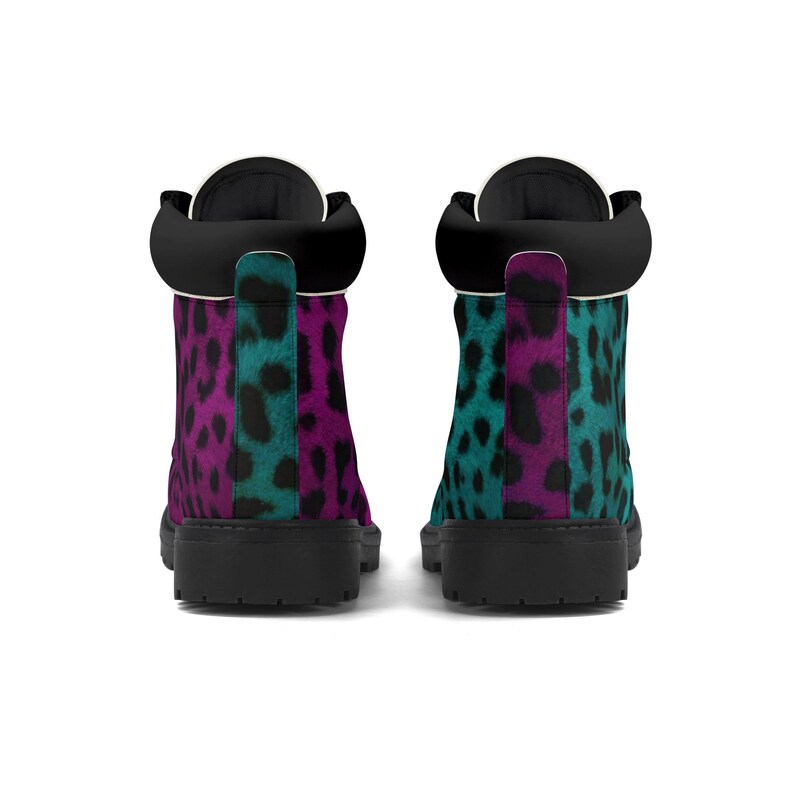 May include: A pair of black leather boots with a pink and teal leopard print design. The boots have a lace-up closure and a round toe.
