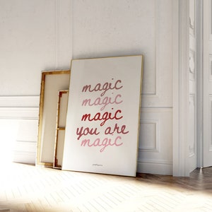 May include: A white poster with the text "magic magic magic you are magic" in a gradient of pink and red.