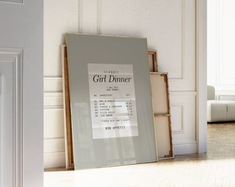 May include: A framed print with a light gray background and a gold frame. The print features a receipt-style design with the text "Classic Girl Dinner" and a list of ingredients. The text "Bon Appetit" is at the bottom of the print.