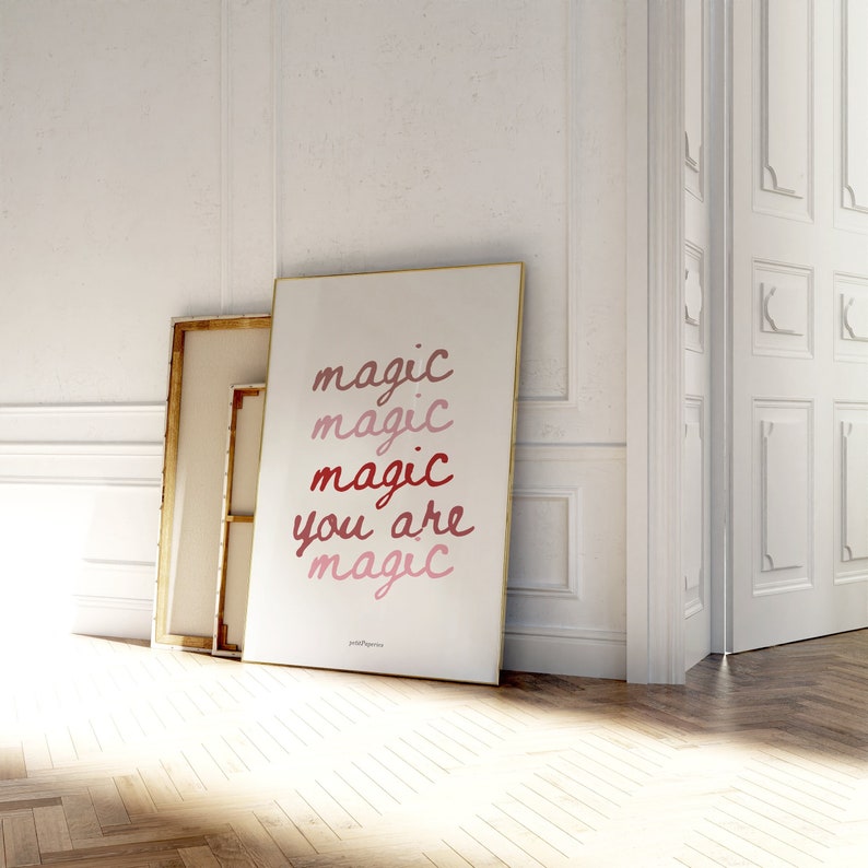 May include: A white poster with the text "magic magic magic you are magic" in a gradient of pink and red.
