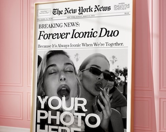 May include: A framed poster with a newspaper design, featuring the headline "Forever Iconic Duo" and the text "Your Photo Here." The black and white image shows two women. The poster is in a gold frame.