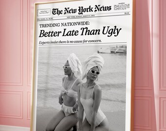 May include: A framed poster featuring a black and white newspaper front page titled The New York News, dated March 8, 2002. The headline reads Trending Nationwide: Better Late Than Ugly. It shows two people in swimwear and head towels on a beach.