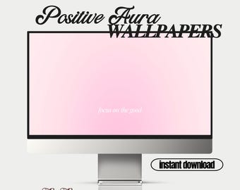 May include: A computer monitor displays a pink gradient wallpaper with the text "focus on the good." The words "Positive Aura WALLPAPERS" are above the screen, and "instant download" is in a black oval. The brand name "Petit Paperies" is at the bottom.
