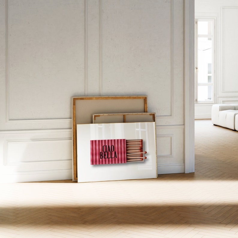 May include: A framed print of a red and white striped matchbox with the text "Ciao Bella" and a row of matches inside.