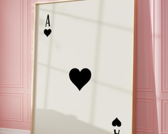 May include: A framed print of an ace of spades playing card with a black heart in the center. The card is on a white background with the text "PRINT PAPERIES" at the bottom.