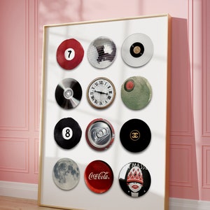 May include: A framed print with a white background featuring 12 round images. The images include a red billiard ball with the number 7, a disco ball, a black and white record, a CD, a clock face, a green circle, a black billiard ball with the number 8, a can of soda, a black circle with the Chanel logo, a moon, a red Coca-Cola can, and a woman's face with a red hat and a red and white patterned design.