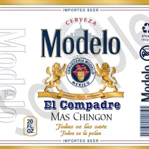 May include: A white beer label with a blue and gold logo for Modelo Cerveza. The logo features a lion and a barrel with the text "Cerveceria Modelo Mexico 1925". The label also includes the text "El Compadre Mas Chingon" and the phrase "Todas se las save Todos se la pelan".