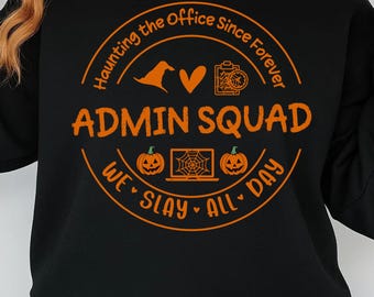 May include: Black sweatshirt with an orange graphic that reads "ADMIN SQUAD" inside a circular design with Halloween-themed icons. The design includes a witch hat, heart, camera, pumpkin, and a laptop with a spiderweb. The text "Haunting the Office Since Forever" and "We Slay All Day" are also included.