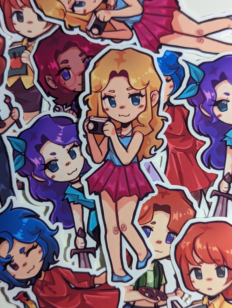 May include: A collection of colorful stickers featuring cartoon characters with different hairstyles and outfits. The characters are holding various objects, including a camera, a paintbrush, and a sword. The stickers are printed on white paper and have a glossy finish.