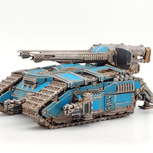 May include: A blue and silver miniature tank with a large gun turret and tracks. The tank is painted with a weathered effect and has a number "21" on the side.