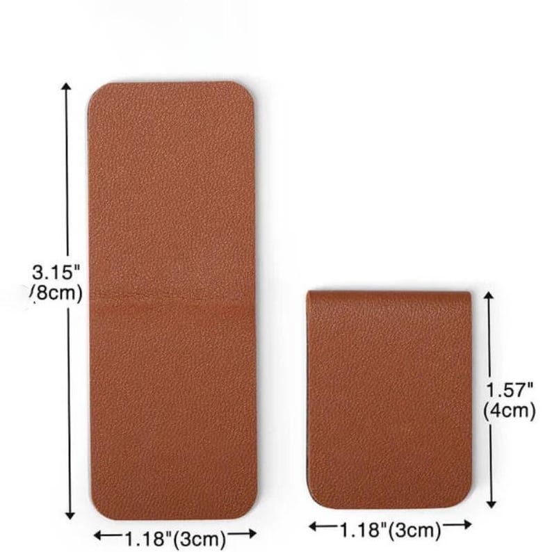 May include: Two brown leather money clips. The larger clip is 3.15 inches (8cm) tall and 1.18 inches (3cm) wide. The smaller clip is 1.57 inches (4cm) tall and 1.18 inches (3cm) wide. Both clips have a rectangular shape with rounded corners.