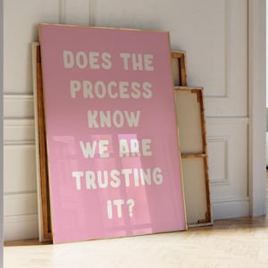 May include: Pink motivational poster with white text that reads "Does the process know we are trusting it?"