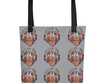 May include: A grey tote bag with a repeating pattern of a dog's face. The dog has grey and white fur with orange accents around the eyes and mouth.