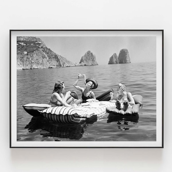 Floating Luncheon | Three young women eat spaghetti on inflatable mattresses at Lake of Capri 1939 | Premium Quality Print