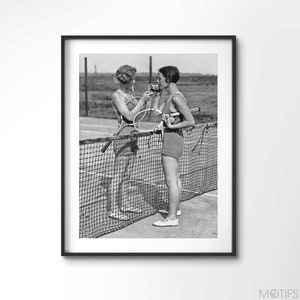 Lighting Up | Vintage | Two women lighting cigarettes on a tennis court in Essex, England circa 1930&#39;s | Premium Quality Print