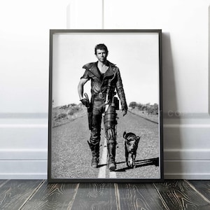 May include: Black and white photograph of a man in a leather jacket and pants walking down a road with a dog. The man is wearing a prosthetic leg and carrying a gun. The dog is a small, brown and white dog.