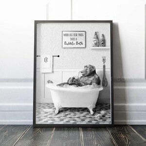 May include: Black and white photo of a chimpanzee taking a bubble bath in a white bathtub. The chimpanzee is holding a glass of something and is relaxing in the bubbles. The sign above the bathtub reads "When all else fails, take a bubble bath."