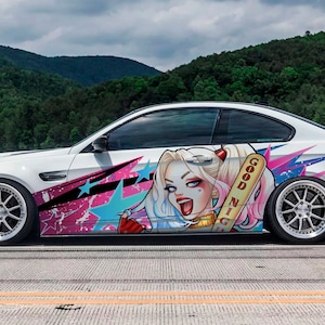 May include: White coupe with custom graphics featuring a cartoon character with blonde pigtails, a baseball bat, and the words "Good Night." The car has custom wheels and is parked on a road with a mountain backdrop.
