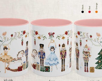 May include: White ceramic mug with a pink interior and handle, featuring a Nutcracker-themed design. The mug showcases illustrations of a clock, ballerina, nutcrackers, and a Christmas tree. The text on the mug reads "nutcracker mug 11oz and 15oz".