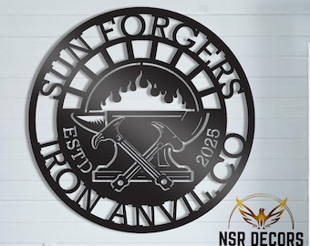 May include: Black metal wall art featuring the words "Sun Forgers Iron Anvil Est'd 2025 Co." in a circular design. The artwork depicts a blacksmith's anvil with a hammer and tongs crossed over it, and flames rising from the anvil.