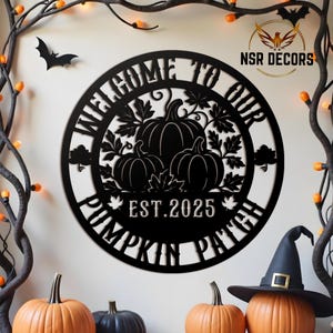 May include: Black metal sign with the text "WELCOME TO OUR PUMPKIN PATCH EST. 2025" and a pumpkin design. The sign is round and has a decorative border. The background includes pumpkins, a witch hat, and Halloween decorations.