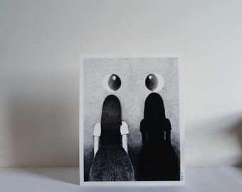 May include: Black and white art print featuring two figures facing away, with large eye-like shapes above them. One figure is a silhouette, the other is detailed with a white top and dark skirt. The artwork has a surreal, dreamlike quality.