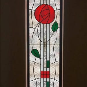 May include: A stained glass window with a red rose design. The rose is surrounded by green leaves and white and black lines.