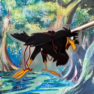 May include: A black crow with a red string tied around its neck, looking to the right with a surprised expression. The crow is standing on a green and blue background with a tree trunk in the background.