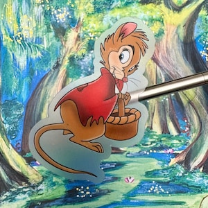 May include: A cartoon mouse wearing a red coat and holding a basket. The mouse has brown fur and a long tail. The background is a watercolor painting of a forest.