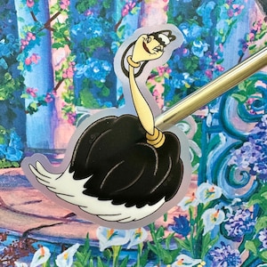 May include: A black and white ostrich with a long neck and a yellow beak. The ostrich is wearing a gold crown and has a surprised expression on its face.