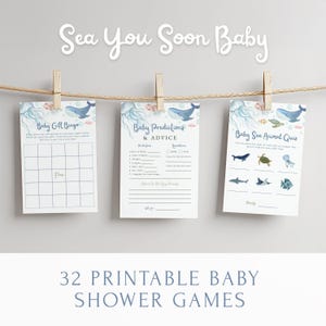 May include: Three baby shower game printables suspended by pegs on a string. The games include a bingo card, a predictions and advice card, and a sea animal quiz. The text "Sea You Soon Baby" is at the top of the image.
