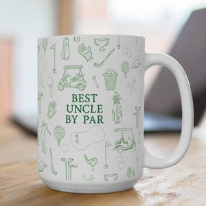 May include: White ceramic mug with a green golf-themed pattern and the text "BEST UNCLE BY PAR." The design includes golf carts, golf balls, flags, and other golf-related illustrations. The mug has a large handle.