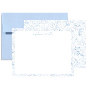 May include: Stationery set featuring a light blue envelope, a matching notecard, and a patterned card. The notecard has the name "sophia smith" in a delicate script. The floral pattern is in shades of blue.