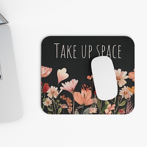 May include: Black mouse pad with a floral border and the text "TAKE UP SPACE" in white.