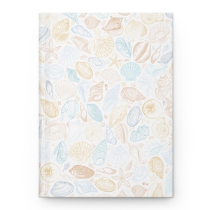 May include: A hardcover journal with a repeating pattern of seashells, starfish, and other marine life in shades of tan, blue, and white. The journal has a clean, minimalist design, perfect for writing or sketching.