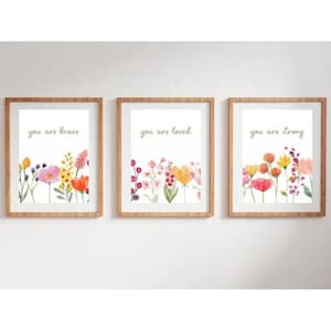 May include: Three framed prints with watercolour illustrations of flowers and the text "you are brave", "you are loved", and "you are strong".