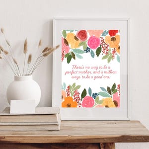 May include: A white framed print with a floral design and the quote "There's no way to be a perfect mother, and a million ways to be a good one."