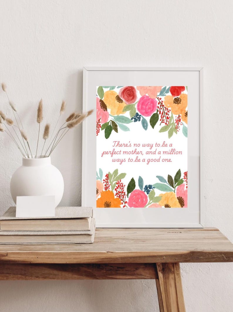 May include: A white framed print with a floral design and the quote "There's no way to be a perfect mother, and a million ways to be a good one."