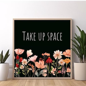 May include: A black and white print with the text "Take Up Space" in white lettering. The print features a border of watercolor flowers in shades of pink, red, and orange.