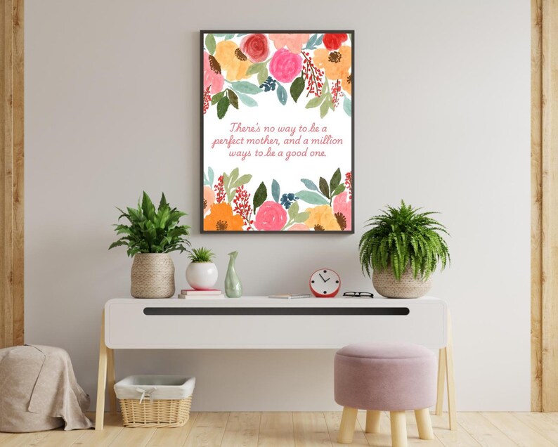 May include: A framed print with a white background and colourful floral illustrations. The text reads "There's no way to be a perfect mother, and a million ways to be a good one."