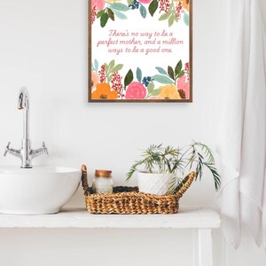 May include: A framed print with a floral design and a quote that reads "There's no way to be a perfect mother, and a million ways to be a good one."