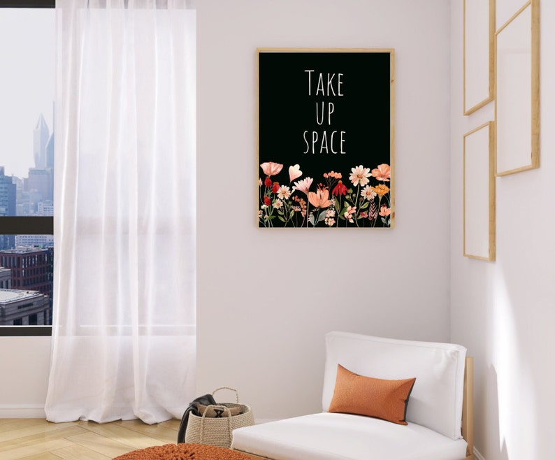 May include: A black and white printable art print with the text "Take Up Space" and a floral design in shades of pink, orange, and red.