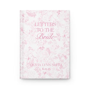 May include: A white journal with a pink floral pattern and the text "LETTERS TO THE Bride". The journal also includes the name "OLIVIA LYNN SMITH" and the date "8.15.25" in pink script. The cover has a soft, romantic aesthetic.