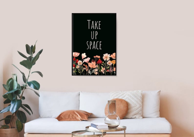 May include: Black and white print with the text "TAKE UP SPACE" in white lettering. The print features a row of colorful flowers at the bottom.