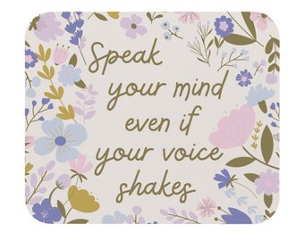 May include: A light pink and white background with a floral pattern. The text "Speak your mind even if your voice shakes" is written in brown cursive font.