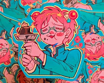 Puede incluir: Una pegatina con una ilustración de dibujos animados de una persona con pelo rosa y gafas sosteniendo un postre. El personaje lleva una chaqueta turquesa y la pegatina tiene un fondo azul con un patrón de puntos.