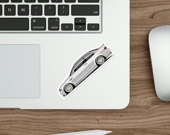 May include: A white BMW M3 E46 car sticker with yellow wheels. The car is facing the right side and is on a white laptop.