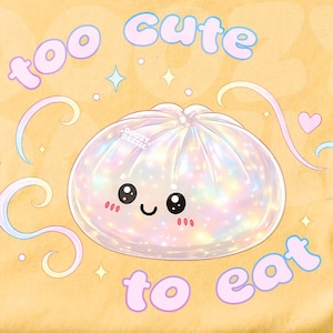May include: Yellow t-shirt with a graphic of a cute, smiling dumpling and the text "too cute to eat" in pink and blue. The shirt has a round neckline and short sleeves.