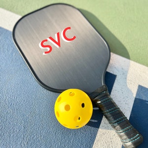 Pickleball paddle art with unique design elements Customized paddle gift with custom features Pickleball enthusiast present with personalized touch Unique paddle design crafted for pickleball lovers