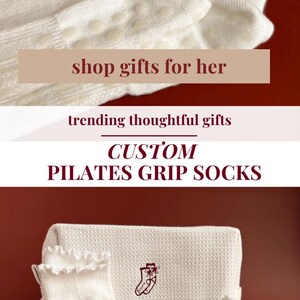 May include: White custom Pilates grip socks with a burgundy bow and monogram. The socks have a ruffled edge and a non-slip grip. A matching white waffle-weave towel is also in the image. Text on the image says "shop gifts for her".